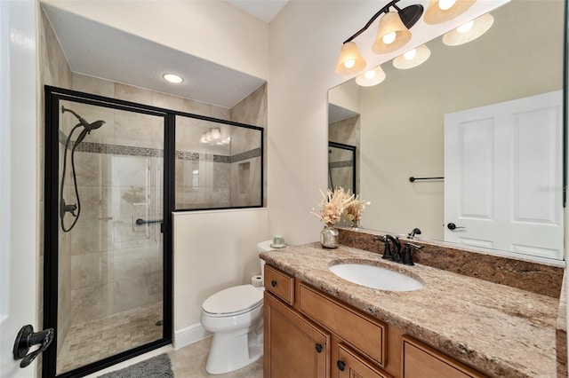 bathroom with vanity, tile patterned flooring, toilet, and walk in shower