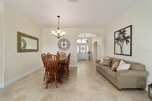 dining room with a notable chandelier and light tile patterned flooring