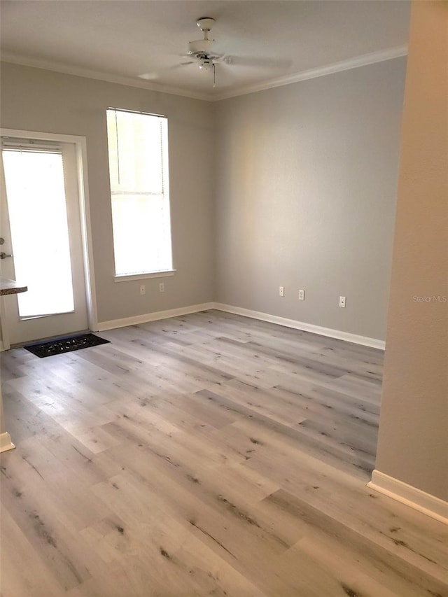 spare room featuring hardwood / wood-style flooring, ornamental molding, and ceiling fan