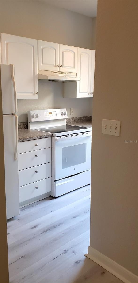 kitchen featuring light hardwood / wood-style flooring, white cabinetry, and white appliances