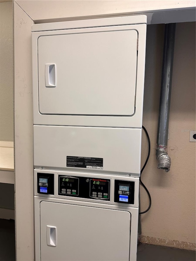 laundry room with stacked washing maching and dryer