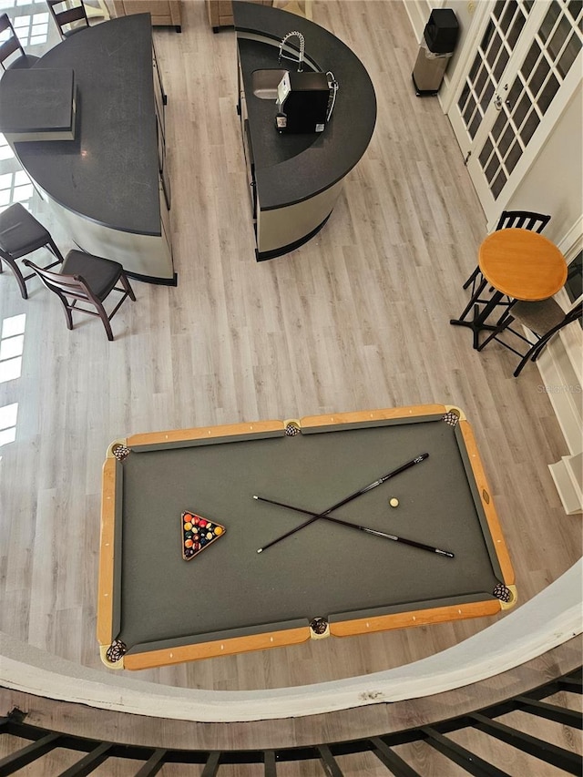 game room with wooden walls and wood-type flooring