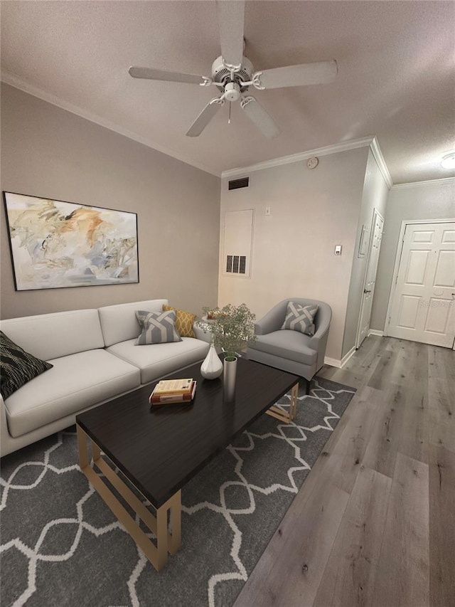 living room with crown molding, ceiling fan, a textured ceiling, and light wood-type flooring