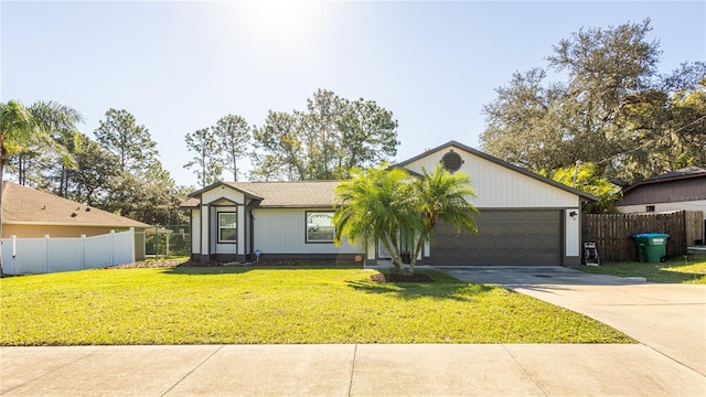 ranch-style house featuring a garage and a front lawn