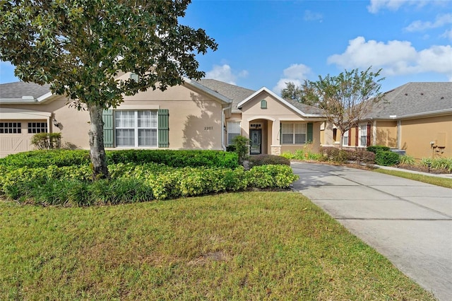 view of front facade featuring a front lawn and a garage