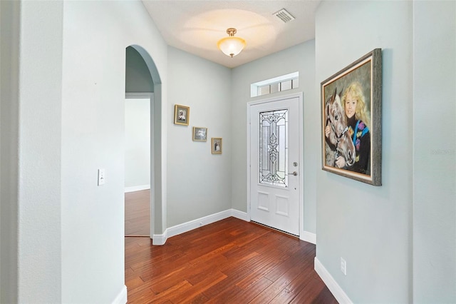 entryway with dark wood-type flooring