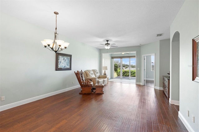 unfurnished room featuring ceiling fan with notable chandelier and dark hardwood / wood-style flooring