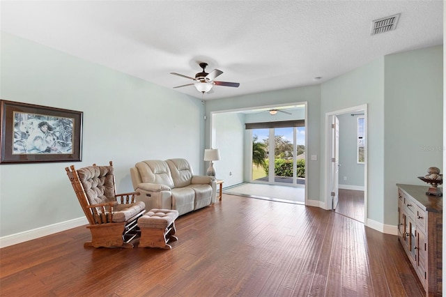 sitting room featuring ceiling fan, a textured ceiling, and dark hardwood / wood-style floors