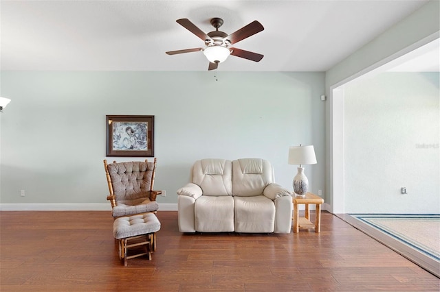 sitting room featuring hardwood / wood-style floors and ceiling fan