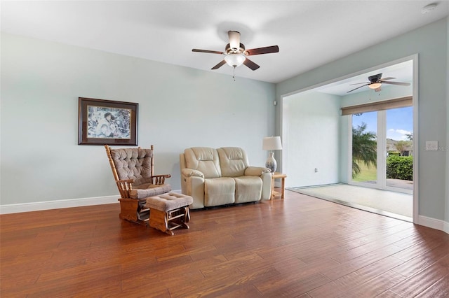 living room with wood-type flooring and ceiling fan