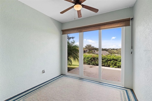 unfurnished room featuring plenty of natural light and ceiling fan