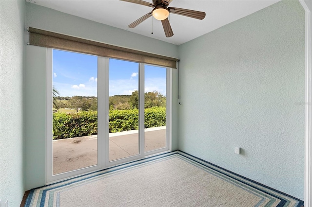 interior space featuring carpet floors and ceiling fan