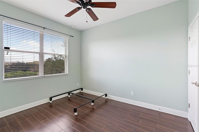 unfurnished room featuring dark wood-type flooring and ceiling fan