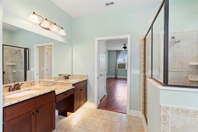 bathroom featuring vanity, hardwood / wood-style floors, walk in shower, and ceiling fan