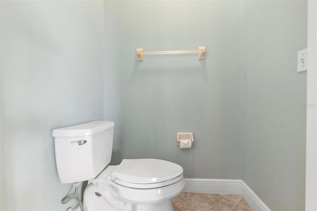 bathroom featuring toilet and tile patterned flooring