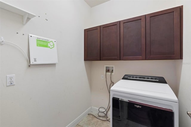 laundry room featuring washer / dryer and cabinets