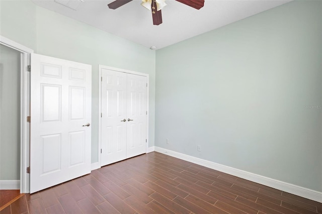 unfurnished bedroom with a closet, dark hardwood / wood-style floors, and ceiling fan