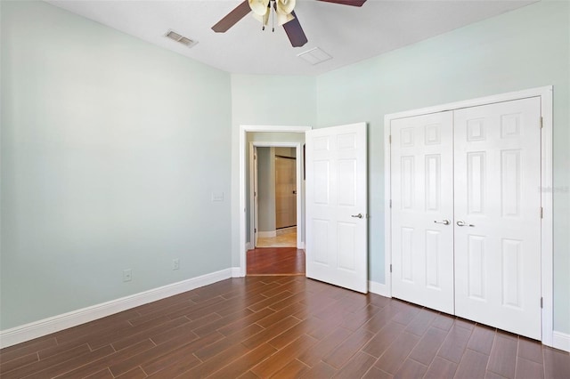 unfurnished bedroom featuring a closet, dark hardwood / wood-style floors, and ceiling fan