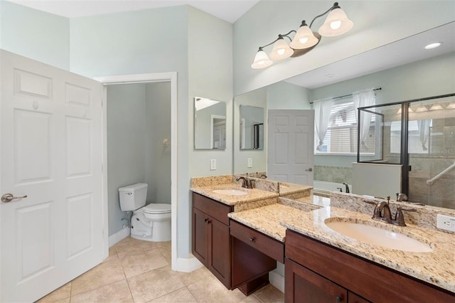 bathroom with vanity, tile patterned floors, toilet, and an enclosed shower