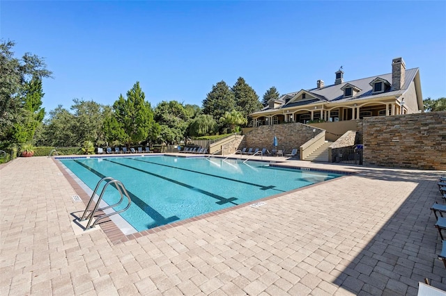 view of swimming pool with a patio