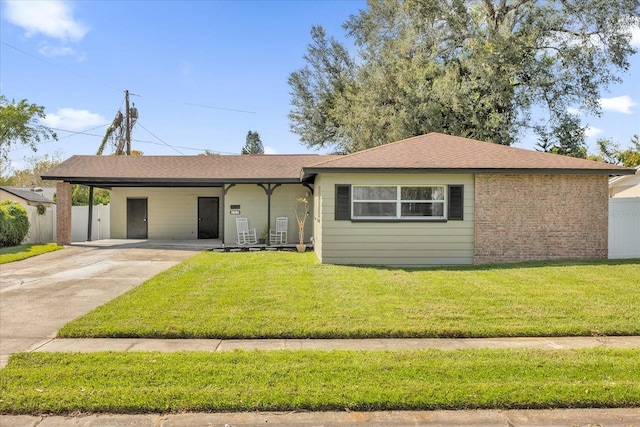 ranch-style house with a carport and a front yard