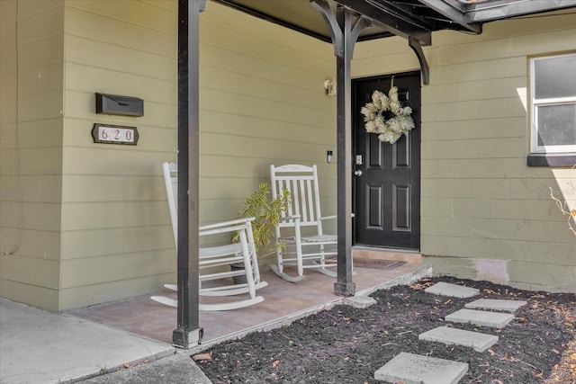 view of exterior entry featuring a porch