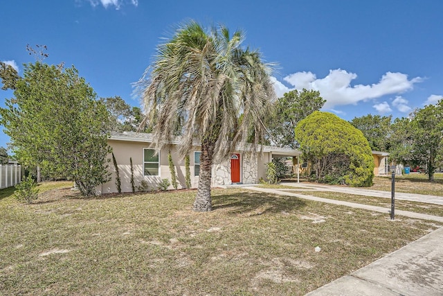6445 Skyline Ct, Spring Hill, FL 34606 - obstructed view of property with stucco siding, driveway, and a carport