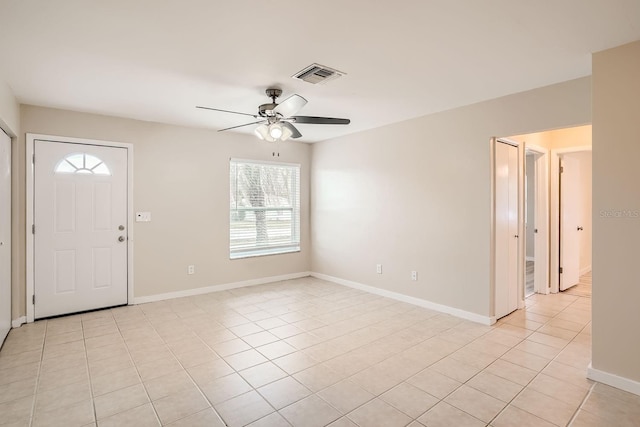 tiled entrance foyer featuring a healthy amount of sunlight and ceiling fan