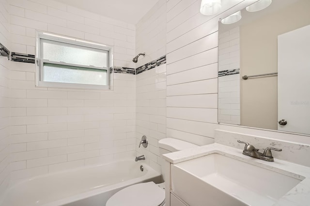 full bathroom with tiled shower / bath, toilet, and vanity