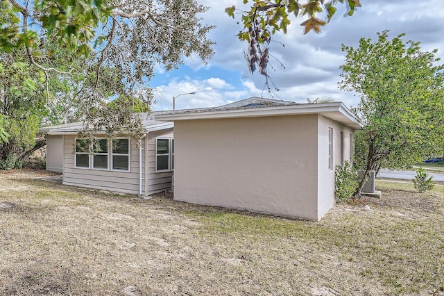 view of side of property with a yard