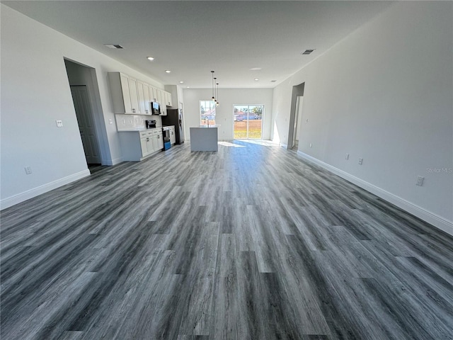 unfurnished living room with dark hardwood / wood-style floors