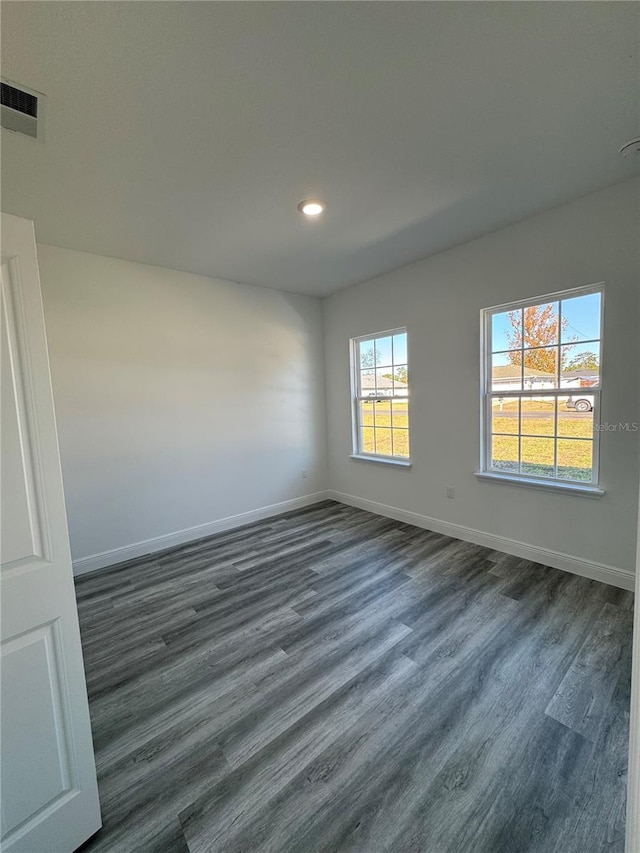 unfurnished room featuring dark hardwood / wood-style flooring