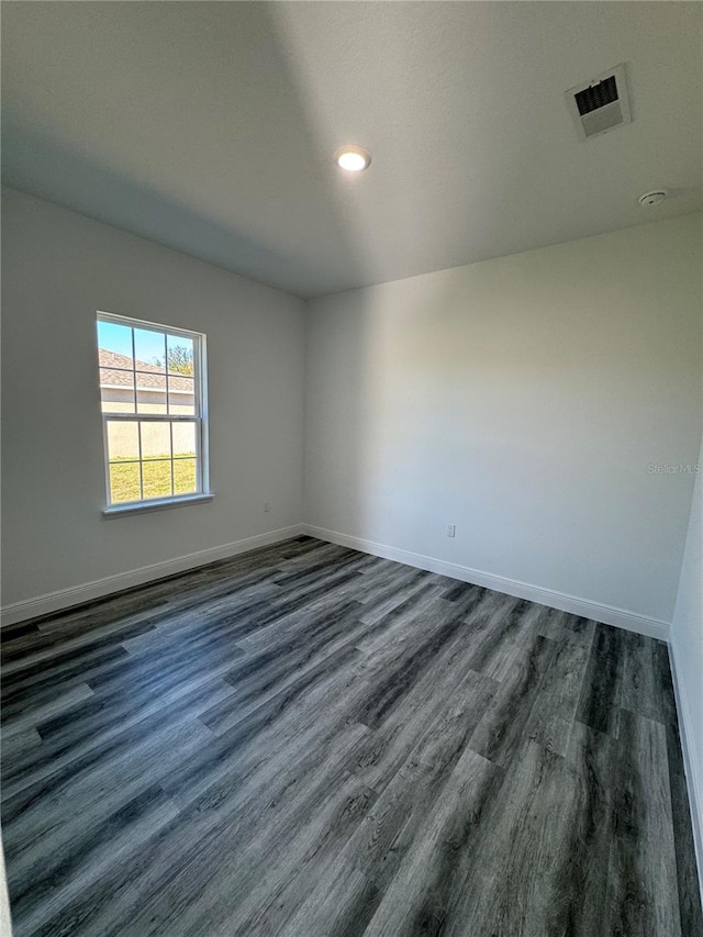 spare room featuring dark hardwood / wood-style floors