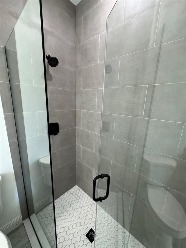 bathroom featuring toilet and walk in shower