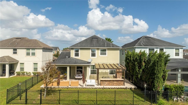 rear view of house with a patio area, outdoor lounge area, and a lawn