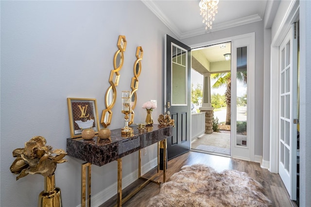 doorway to outside with ornamental molding and hardwood / wood-style floors