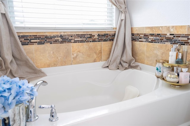 bathroom with a tub to relax in