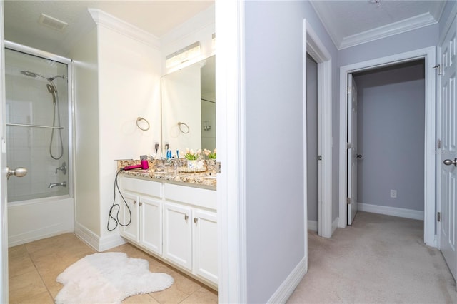 bathroom featuring vanity, enclosed tub / shower combo, tile patterned floors, and ornamental molding