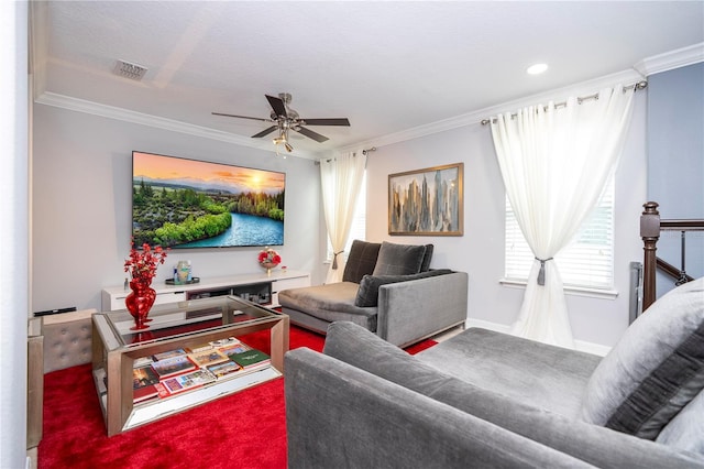 living room featuring crown molding, carpet floors, and ceiling fan