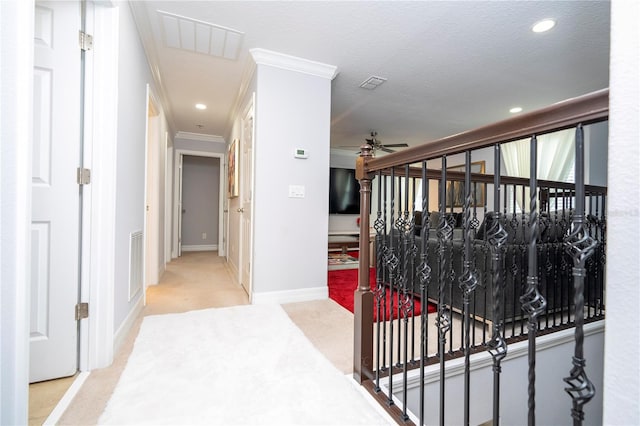 hall with crown molding, a textured ceiling, and carpet floors