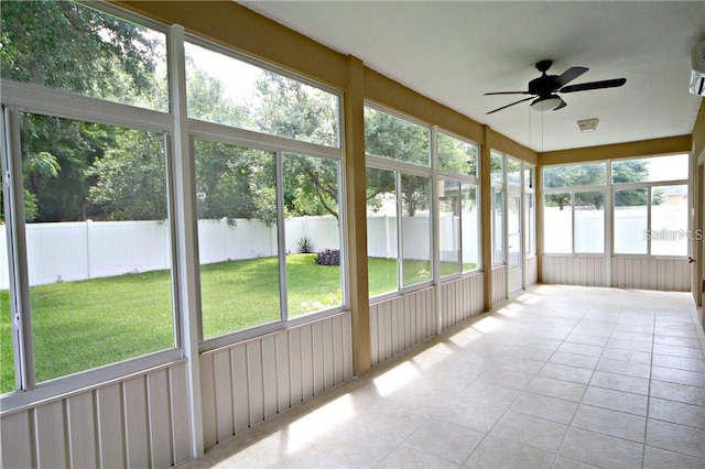 unfurnished sunroom featuring ceiling fan