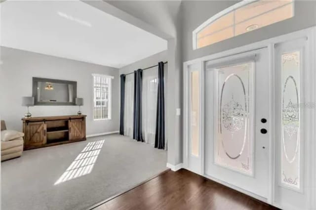 entryway with wood finished floors and baseboards