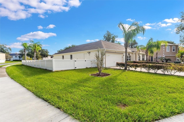 view of side of property featuring a yard and a garage