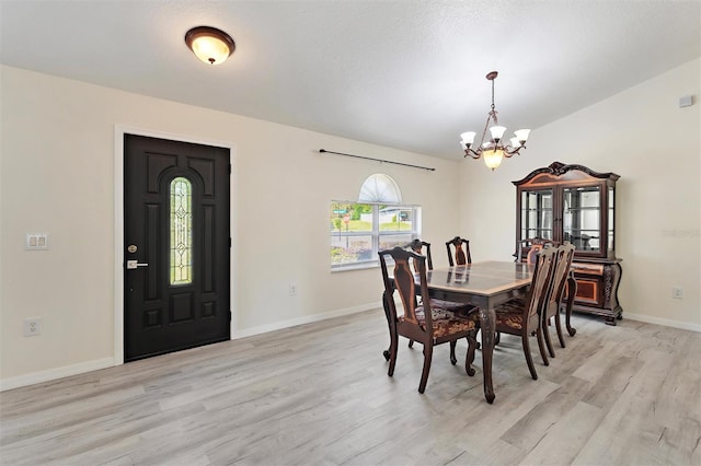 dining space featuring a chandelier and light wood-type flooring