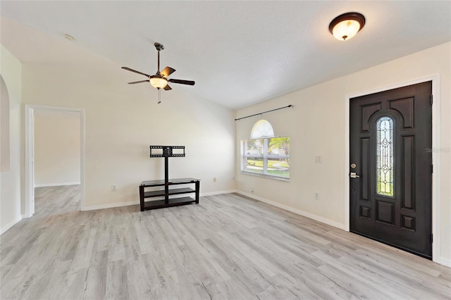 foyer entrance featuring lofted ceiling, a textured ceiling, light wood-type flooring, and ceiling fan