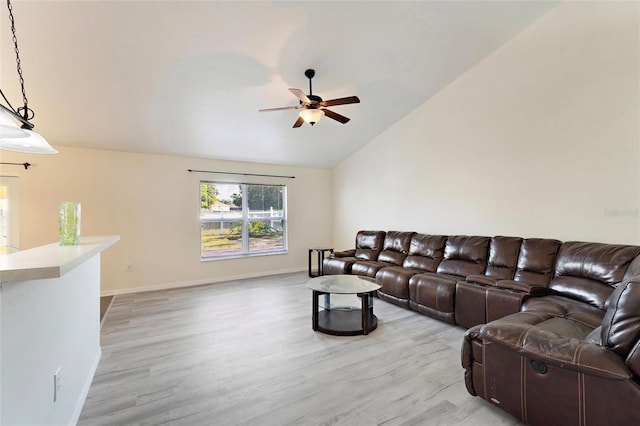 living room featuring lofted ceiling, light wood-type flooring, and ceiling fan