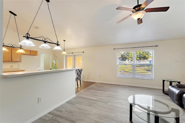 unfurnished living room featuring light hardwood / wood-style flooring and ceiling fan