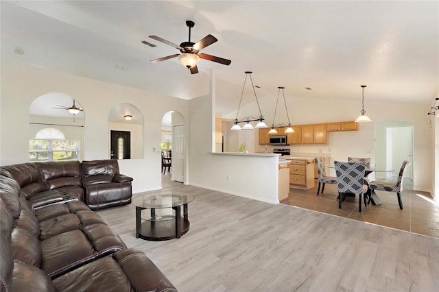 living room featuring light hardwood / wood-style floors, high vaulted ceiling, and ceiling fan