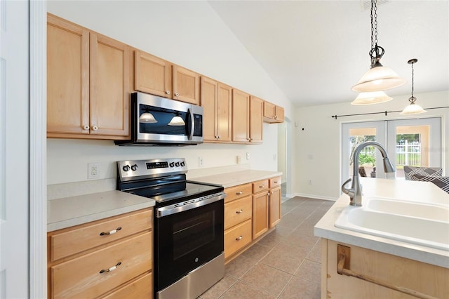 kitchen with lofted ceiling, light brown cabinets, french doors, a sink, and stainless steel appliances