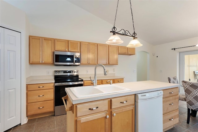 kitchen with a sink, light countertops, lofted ceiling, light brown cabinets, and stainless steel appliances